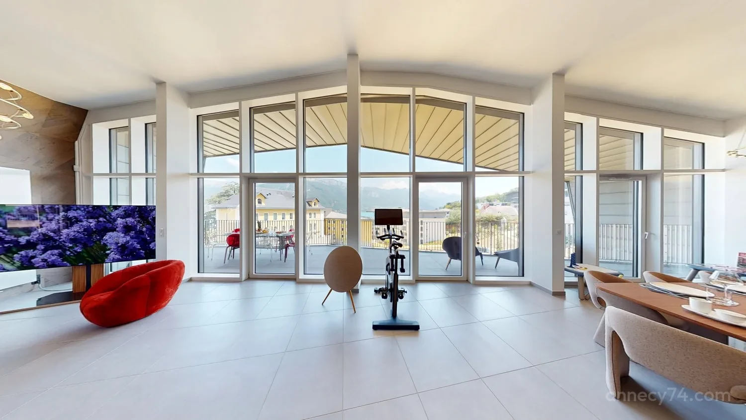The living room of the Annecy74 penthouse, opening onto a terrace above Lake Annecy
